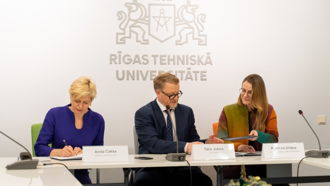 Anda Čakša, Tālis Juhna un Ramona Urtāne sēž pie galda memoranda parakstīšanā