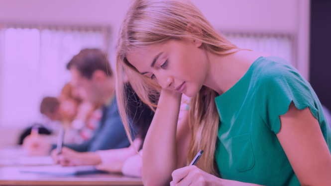 Meitene zaļā apģērbā raksta eksāmenu