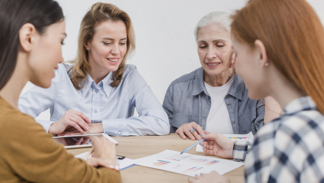 Četras dažāda vecuma sievietes sēž pie galda un pārrunā plānu