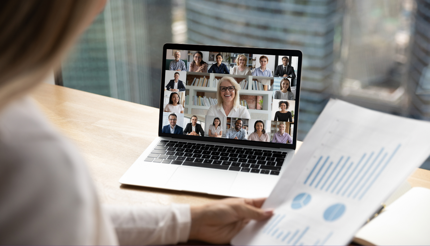 Uz galda stāv dators, tajā notiek online seminārs