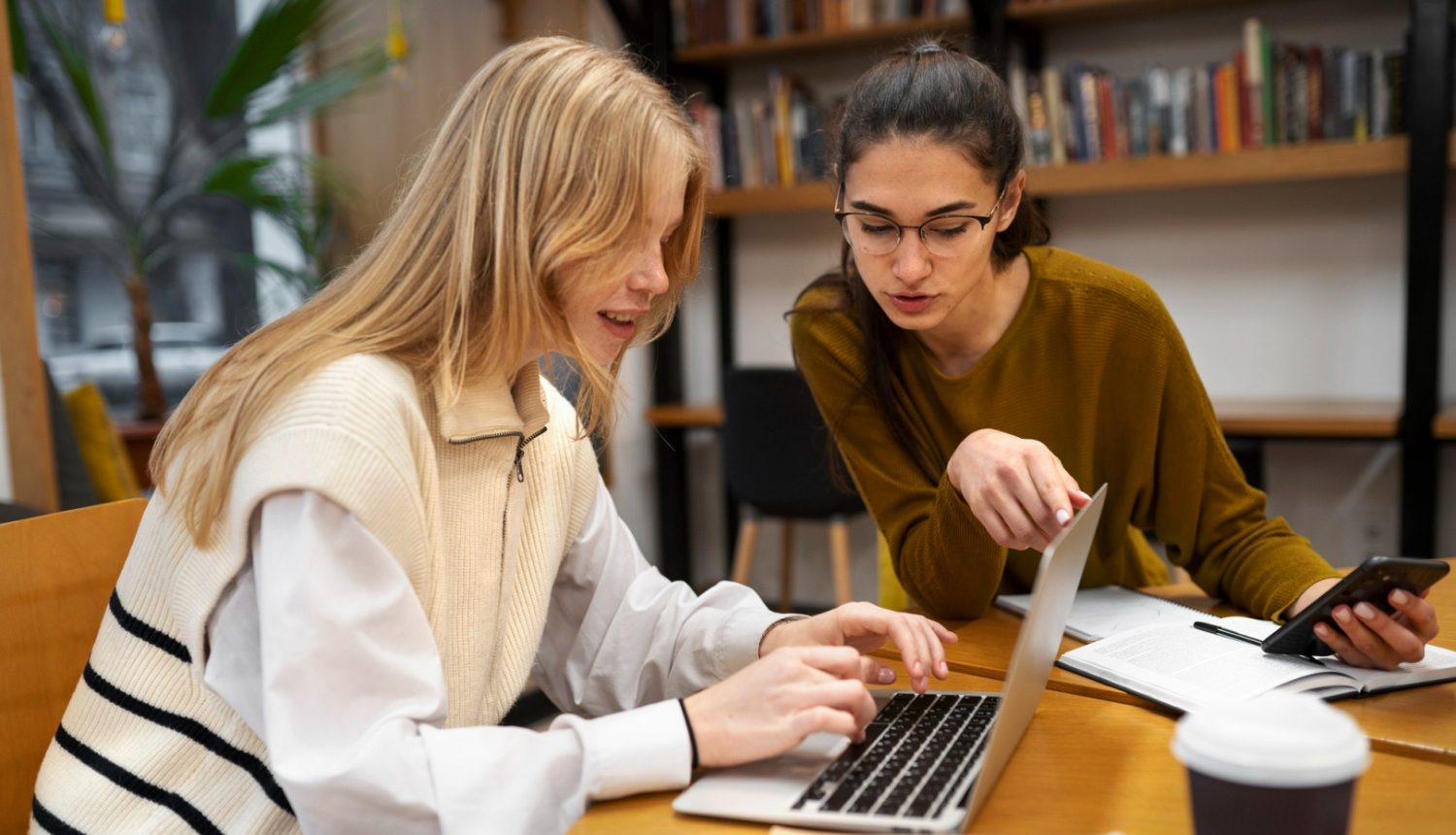 Divas studentes mācās pie datora 